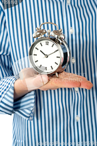 Image of Boys palm holding alarm clock