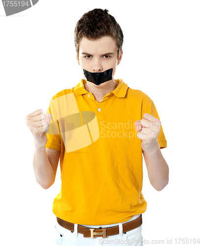 Image of Angry boy with masking tape on mouth.