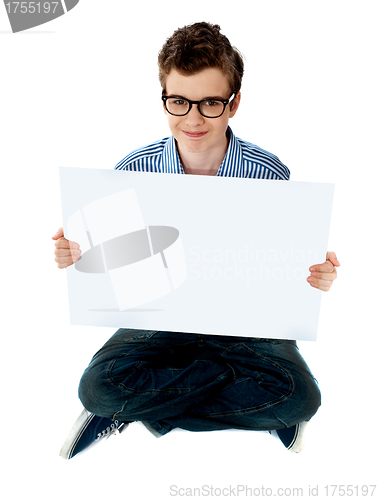 Image of Smiling boy presenting blank whiteboard