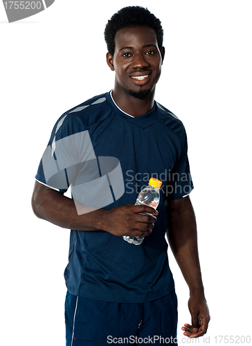 Image of Handsome man holding water bottle