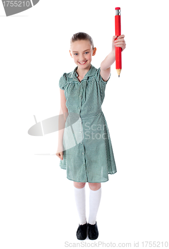 Image of Attractive girl showing big red pencil