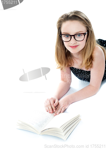 Image of Girl wearing eyeglasses and reading book