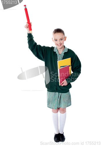 Image of Pretty girl showing pencil upwards