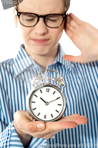 Image of Boy irritated with noise of alarm clock