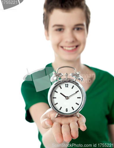 Image of Adorable boy with a alarm clock