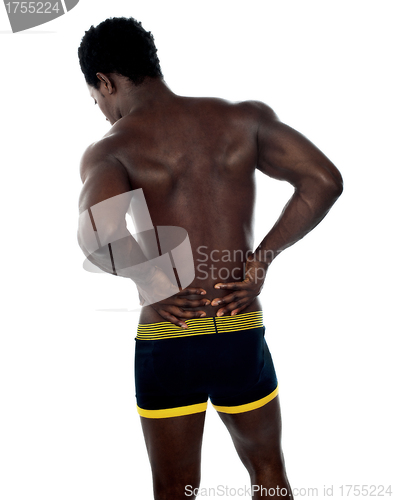 Image of Back pose of young fit male trainer