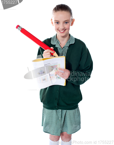 Image of Beautiful girl drawing on her text book