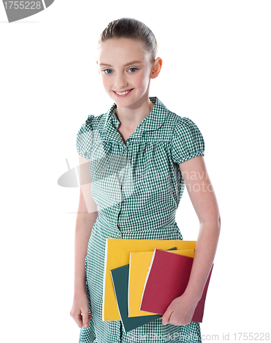 Image of School girl carrying books in hand