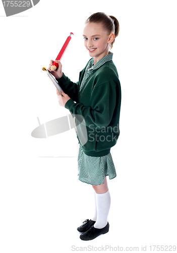 Image of School girl drawing with big pencil