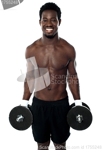 Image of Attractive man posing with dumbbells