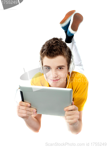 Image of Boy lying on a floor with wireless device