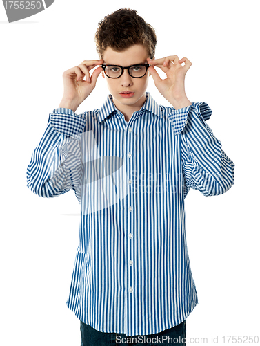 Image of Young boy holding eyeglasses