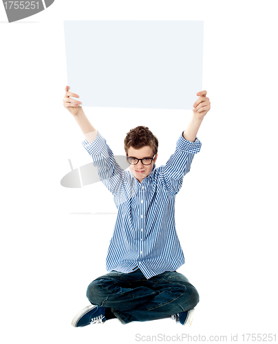 Image of Young kid holding empty placard over his head