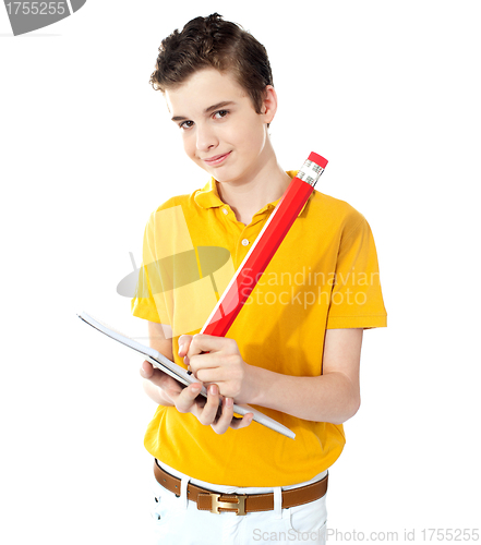 Image of Cute boy writing on his notebook