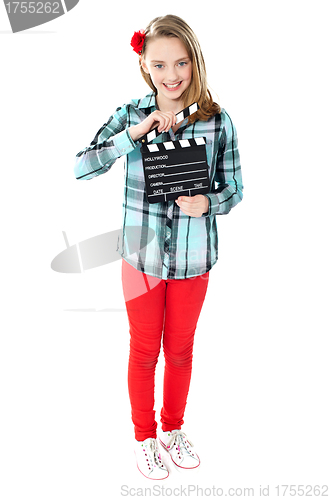 Image of Smiling girl holding clapperboard