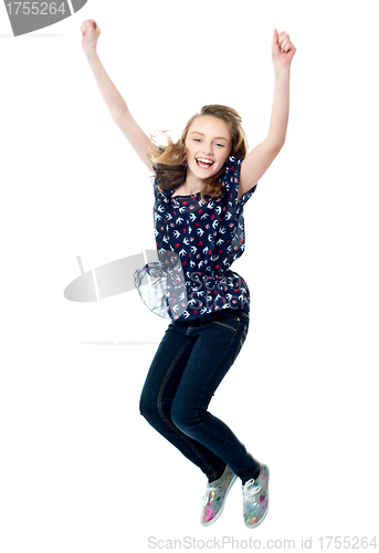 Image of Young girl jumping in excitement