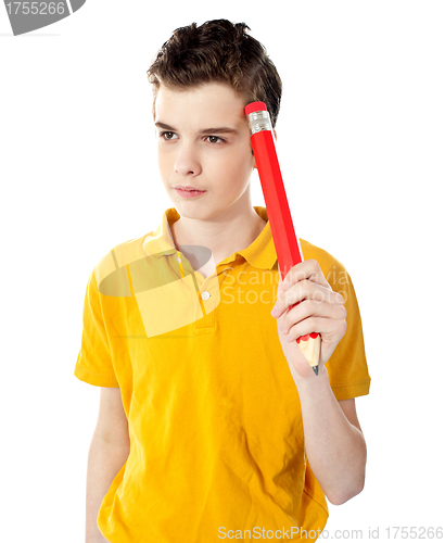 Image of Thoughtful boy holding a pencil