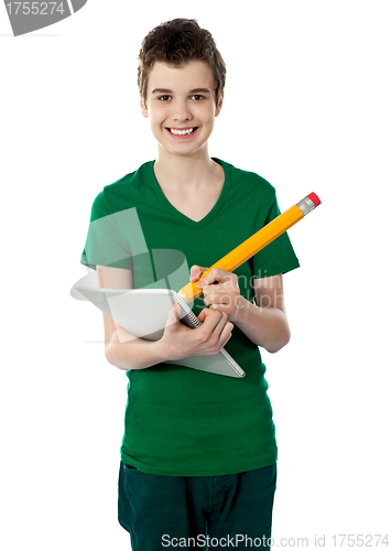 Image of Smiling boy drawing on notebook