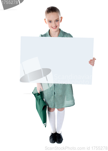 Image of Cute school girl with an advertising board