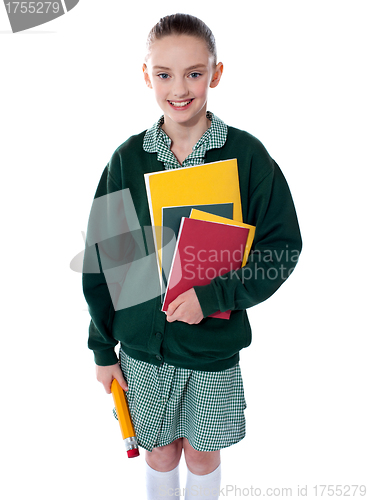 Image of School girl standing with notebooks