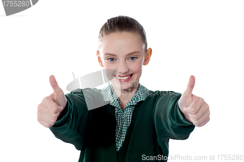 Image of Little girl showing thumbs up to camera