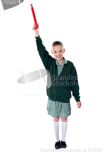 Image of Beautiful girl holding big pencil over her head