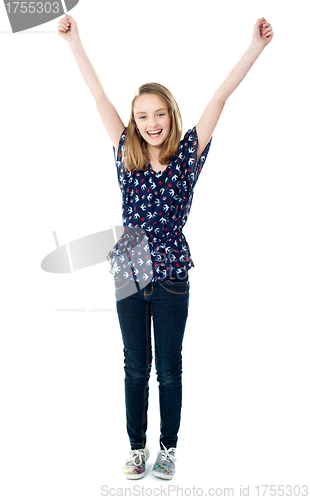 Image of Excited school girl with raised arms