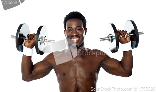 Image of Male athlete holding dumbbells