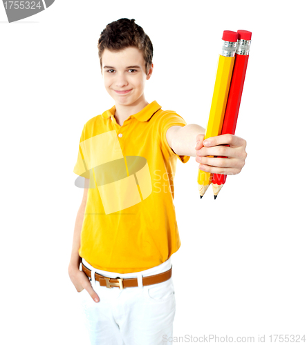 Image of Stylish boy showing two large pencils