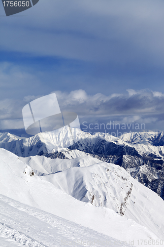 Image of Ski slope and snowy mountains