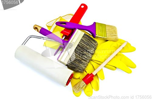 Image of Brushes of various sizes with yellow gloves and roller