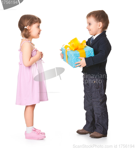 Image of Little boy  giving a gift box to her girlfriend