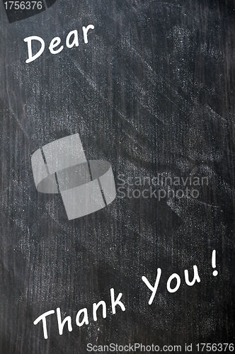 Image of Thank you written with chalk on blackboard with copy space for extra text 