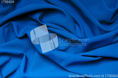 Image of The folds of a bright blue cloth. Abstract Background