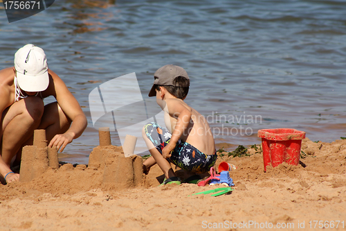 Image of mother and child building sand castle