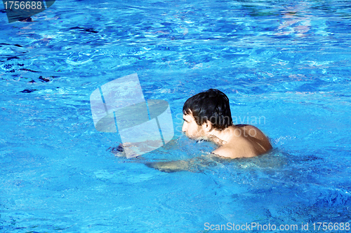 Image of young swimmer in blue water