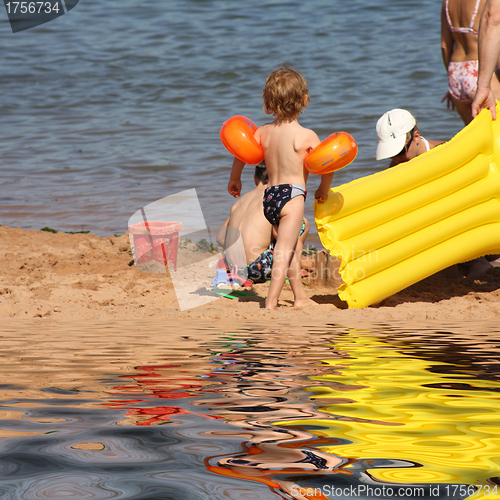 Image of Mother with child on beach