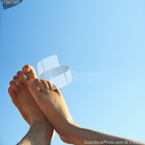 Image of male and female legs on beautiful summer background