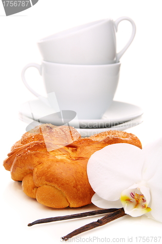 Image of Bun,vanilla and a flower. 