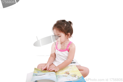 Image of Beautiful toddler girl reading a book 