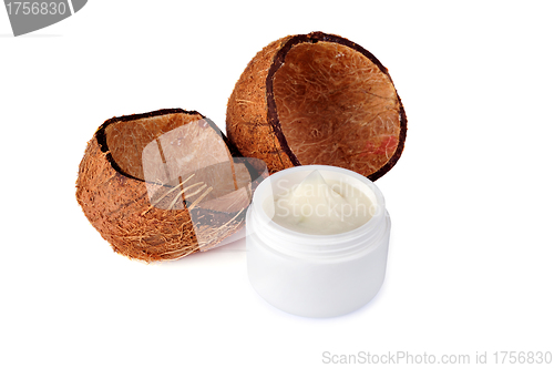 Image of Coconut shells and a jar of cream