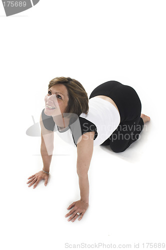 Image of woman in white t-shirt doing yoga