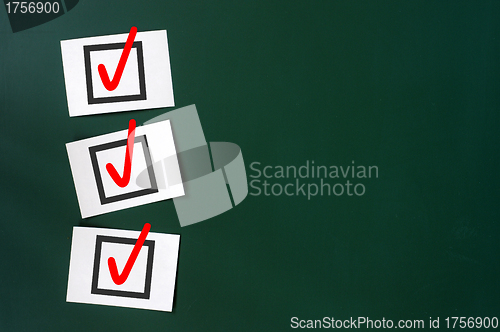 Image of Check box with red tick on a green chalkboard