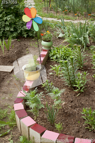 Image of Various old objects decorate the garden