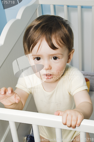 Image of baby standing in his crib