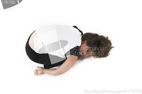 Image of woman in white t-shirt doing yoga