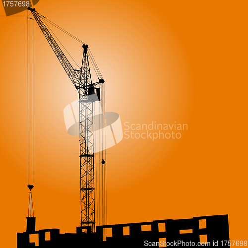 Image of Silhouette of crane on a sunset on a building