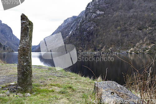 Image of standing stone at coastline in norway