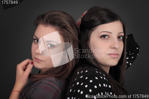 Image of Portrait of two beautiful sexy girlfriends standing together