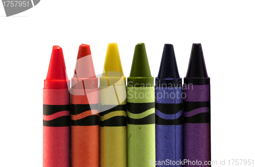 Image of six used colored vax crayons form rainbow